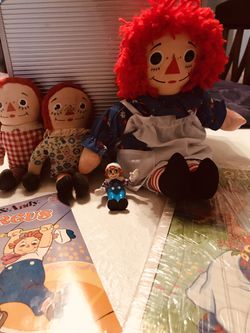 Vintage Raggedy Ann and Andy items (2) 7’ inch and 12’ inch dolls, 2 inch PVC figure See, Hear, Read and 2 25’ inch puzzles in shrink wrap