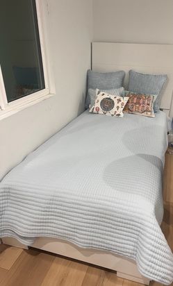 Twin bed with orthopedic mattress