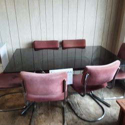 Chrome and glass dining room table with six chairs
