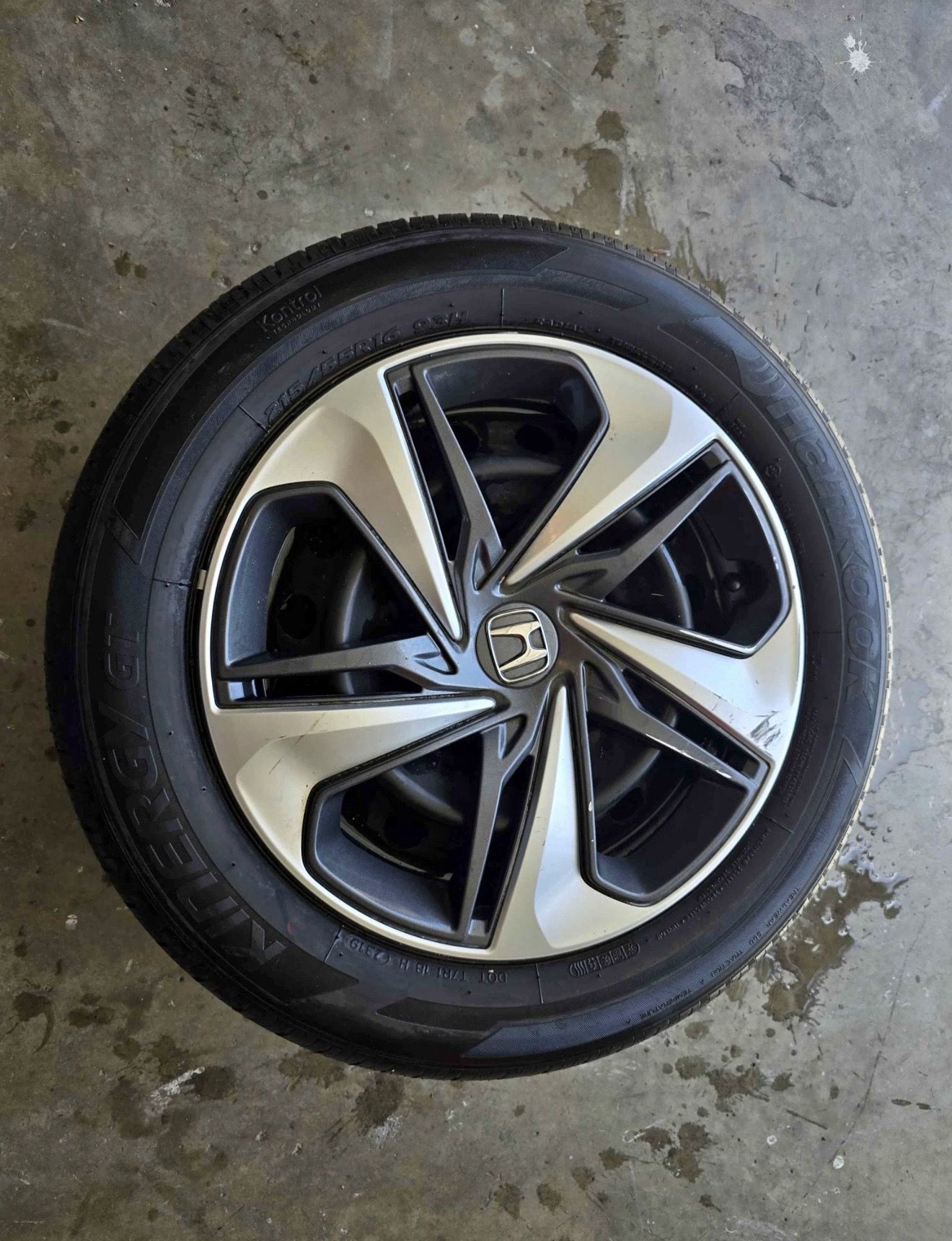 One Honda OEM wheel and hubcaps with Hankook 215/55R16