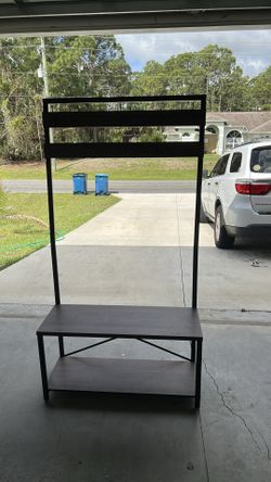 By the door for coats, keys, shoes, and bench
