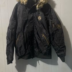 black winter puffer jacket featuring a plush faux-fur trimmed hood.
