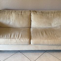Two Beige Loveseat with Nailhead  Trim. From Pier One Import.