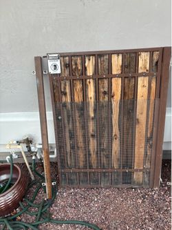 wrought iron and wood slat pedestrian gate