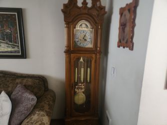 (RARE) vintage Howard Miller grandfather clock, likely the Kingsley model featuring a golden oak finish and a distinct triple-chime movement.