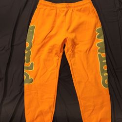 Spider Beluga Orange Sweatpants with Green Lettering