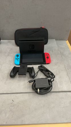 Nintendo switch unit with doc controllers, power cord, and soft case