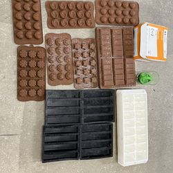 Iron grinder & silicone chocolate molds, including shapes like hearts, stars, smiley faces, flowers, and standard bar molds.