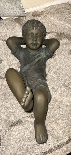 bronze-style child statue with a patina finish.
