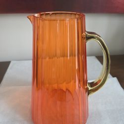 Modern WD Lifestyle fluted orange acrylic pitcher with a gold-tone handle.