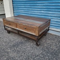 Urban Gold Coffee table. Wheels do not lock. Measures approx: 49" wide x 30" deep x 20.5" tall.