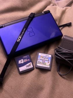 Selling a classic Cobalt Blue Nintendo DS Lite bundle with games and accessories.