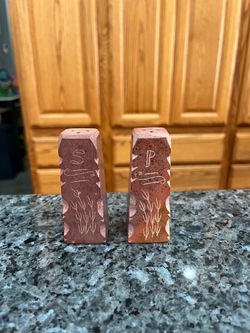 Vintage Carved Stone pair of salt and pepper shakers.  Size approximately 3 1/4 inches tall.  Preowned.