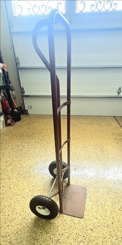 Sturdy metal hand truck dolly with large wheels.