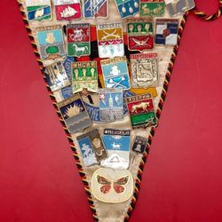 Russian pennant featuring 22 metal pins, each representing a different political theme.