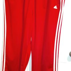 The product is a pair of vintage Adidas Tearaway Track Pants for men in size XL. These wide-leg pants feature a striped pattern with snap buttons and 