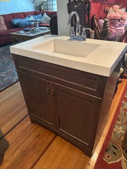 Bathroom, vanity cabinet, sink, and faucets