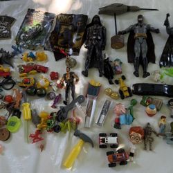 Mixed Toy Lot – Action Figures, Cars, and More Huge variety of vintage and modern toys: Batman, Darth Vader, cars, tools, animals, and fast food toys.