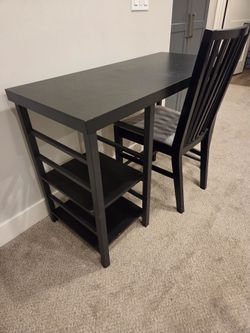 Desk and padded chair with adjustable shelves