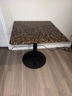 Brown and black marble table