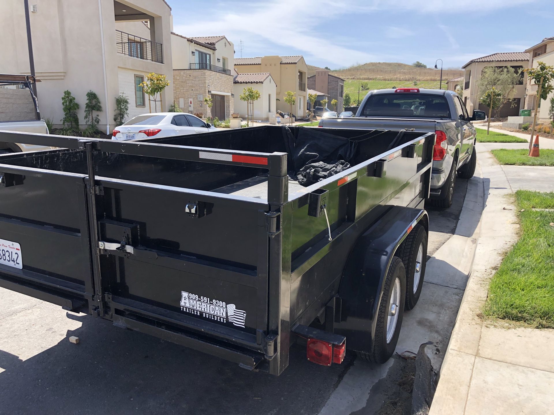 Dump Trailer 8’ ft W x 12’ ft L with braking system, with ramps included for bobcat