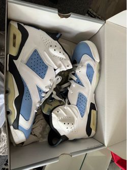 Nike Air Jordan 6 Retro UNC sneakers in a white and University Blue colorway.