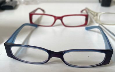 Red designer Versace and blue designer Armani glasses