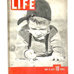 May 10, 1937, issue of LIFE magazine, featuring a boy playing marbles on the cover. The image is titled "Migs," an old term for marbles. 