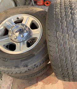 3 Ford F-250 rims/ tires, center caps, 05 ford headlights