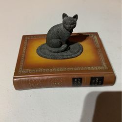 Decorative Cat Sitting On Book