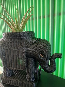 Cute rattan elephant plant stand.