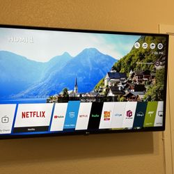 LG 43’ TV With A Wall Mount And A Remote Control 