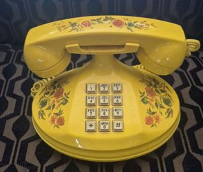 This item is a vintage yellow "Empress" landline telephone, often identified as a 1973 model produced by the American Telecommunications Corporation, 