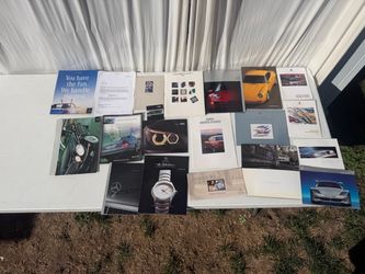 Various brochures from Mercedes and Porsche and BMW from the 1980s to early 2000s