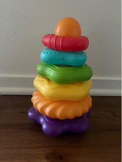 Rainbow plastic stacking ring toy designed for infants and toddlers.