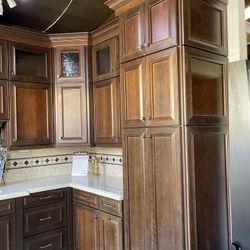 Brand new kitchen cabinets selling display ceiling height must be 108 inches hi cabinets are double stack with glass above it is a cognac Distress