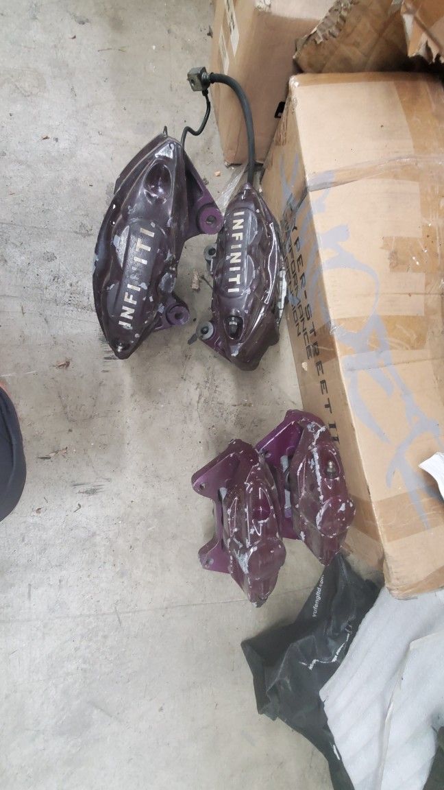 4 OEM Akebono sport brake calipers in silver color, designed for various Infiniti and Nissan models from 2008 to 2020