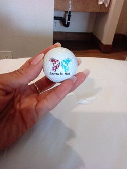 Nike golf ball "Santa Fe, NM" logo and the number 1.