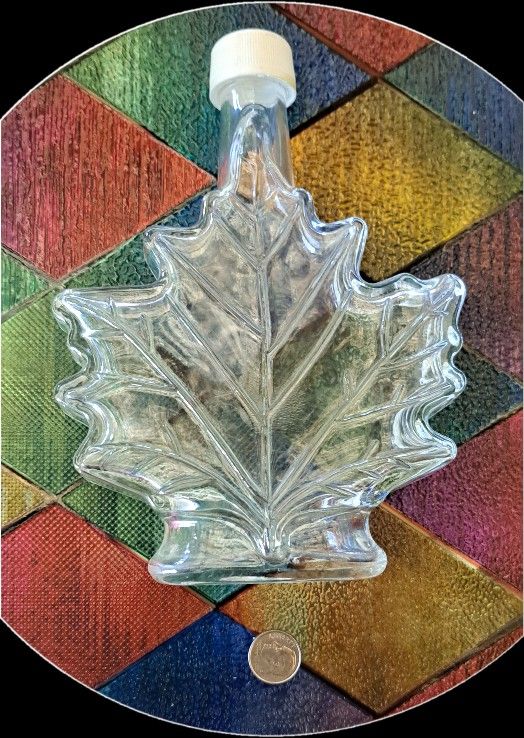 Vintage glass bottle shaped like a maple leaf,