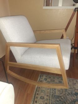 Upholstered rocking chair with padded sear
