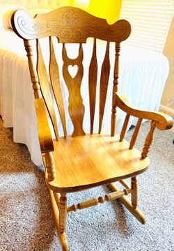 Wooden rocking chair carved back.