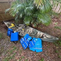 Canoe with paddles ,life jackets and cushions