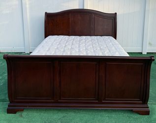 Beautiful King bed is a sled structure in dark cherry color with mattress and Boxspring included can be delivered for an additional cost Price 200