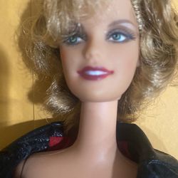 This Barbie doll is a special edition released to celebrate the 25th anniversary of the movie Grease