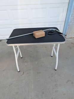 foldable pet grooming table with an adjustable overhead arm