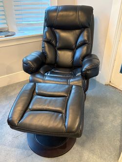 Black reclining leather chair with footstool