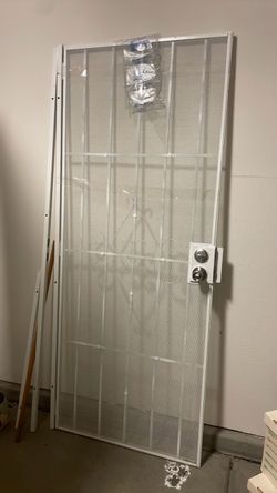 White metal door with frame and lock. No keys