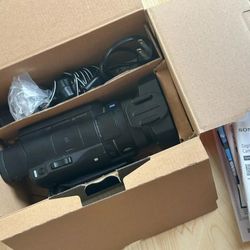 Sony FDR-AX100 4K Camcorder w/3 Batteries, Remote, 64GB Memory Card, power cord