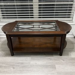 Dark, wooden coffee table with glass