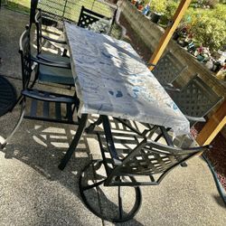 An outdoor set consisting of a large table and 6 chairs.